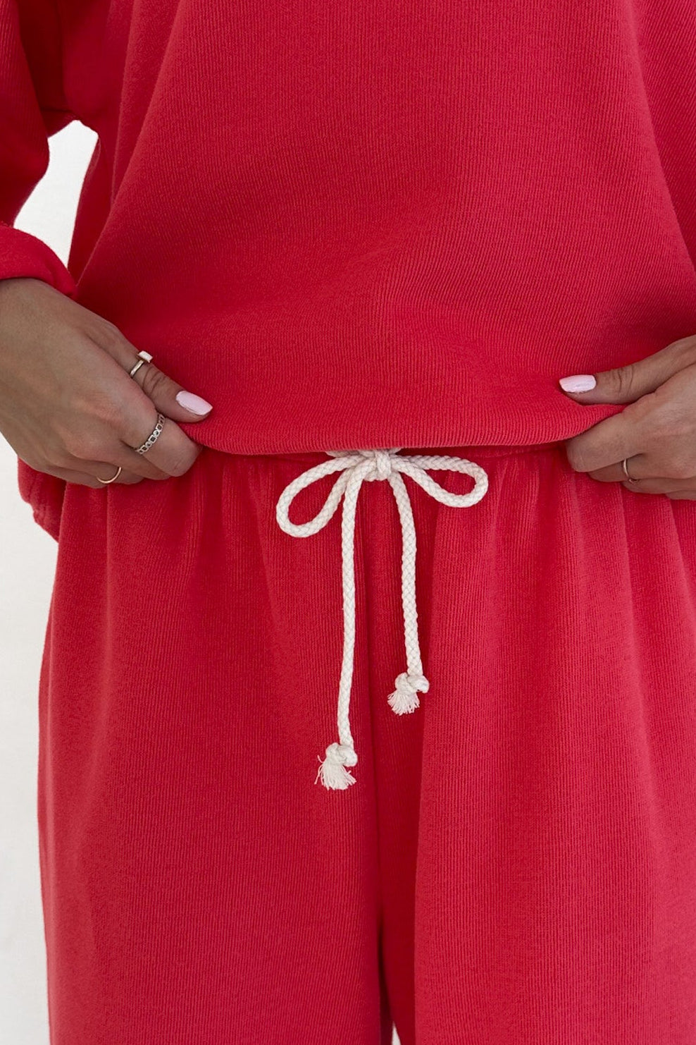 Red sweatshirt and pants with a white drawstring on a white background