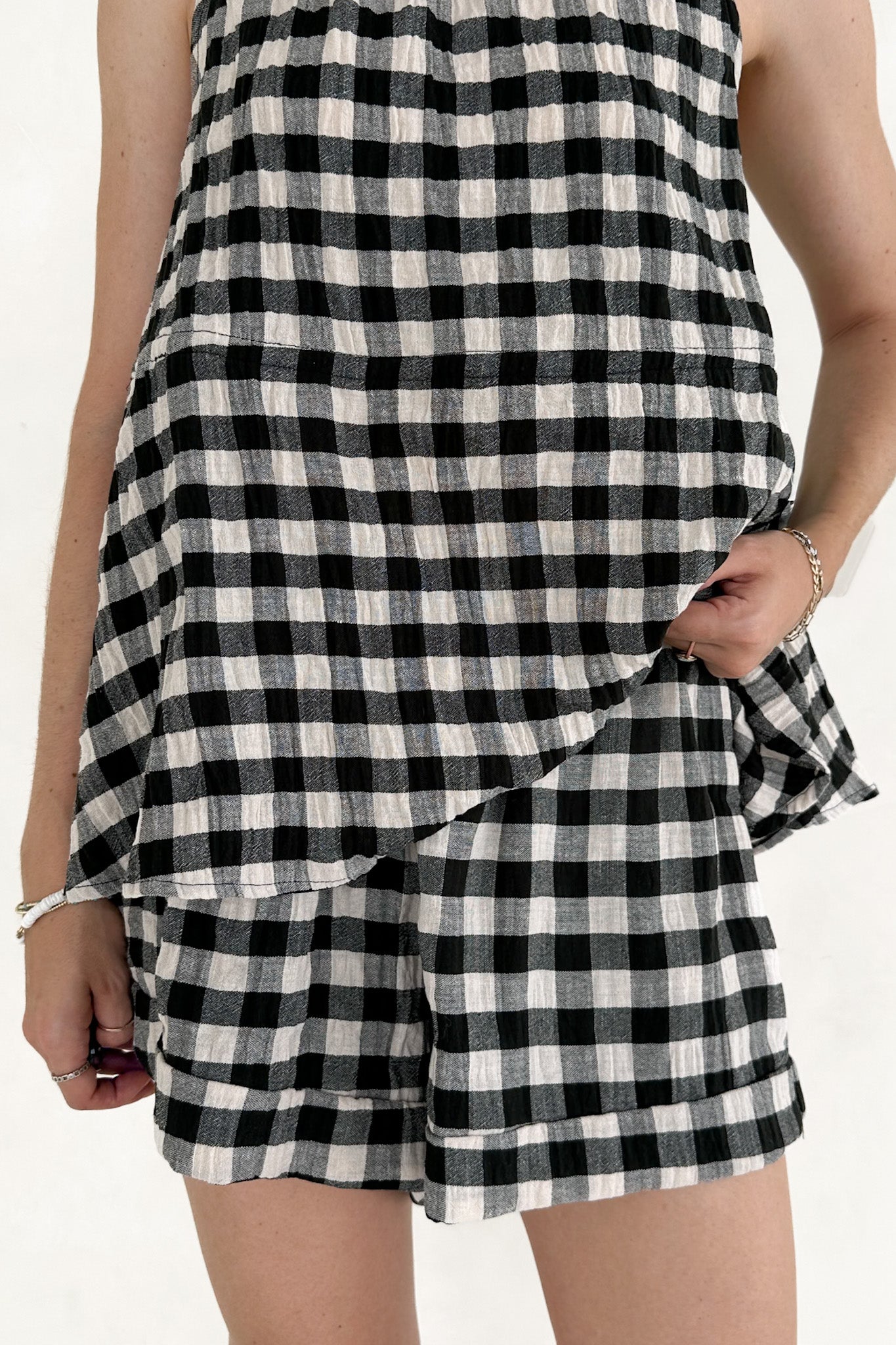 Black and white checkered dress with shorts on a plain background