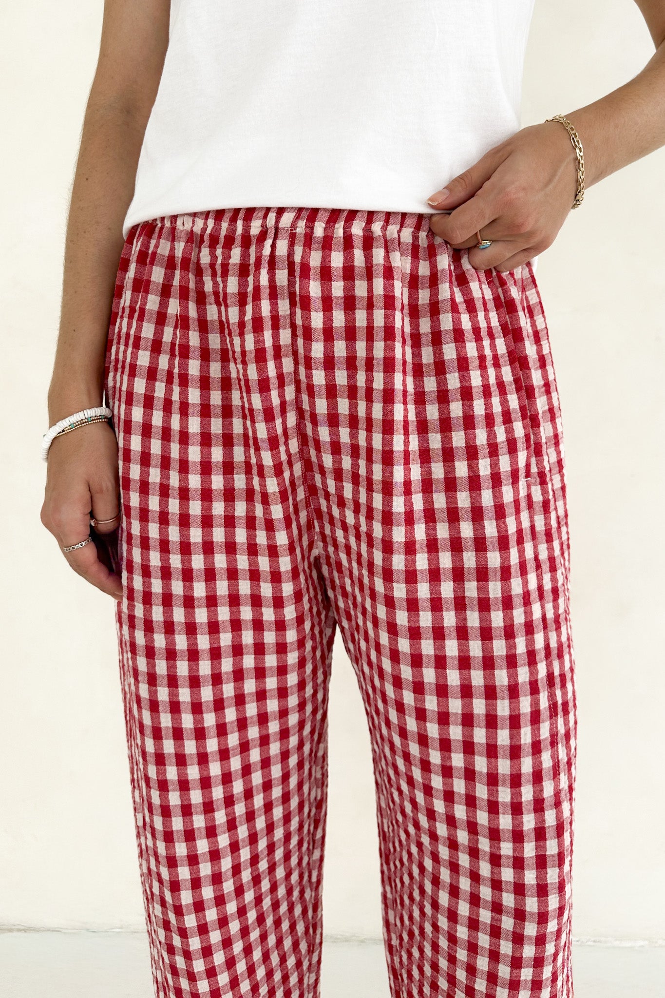 Red and white checkered pants worn by a person on a plain background