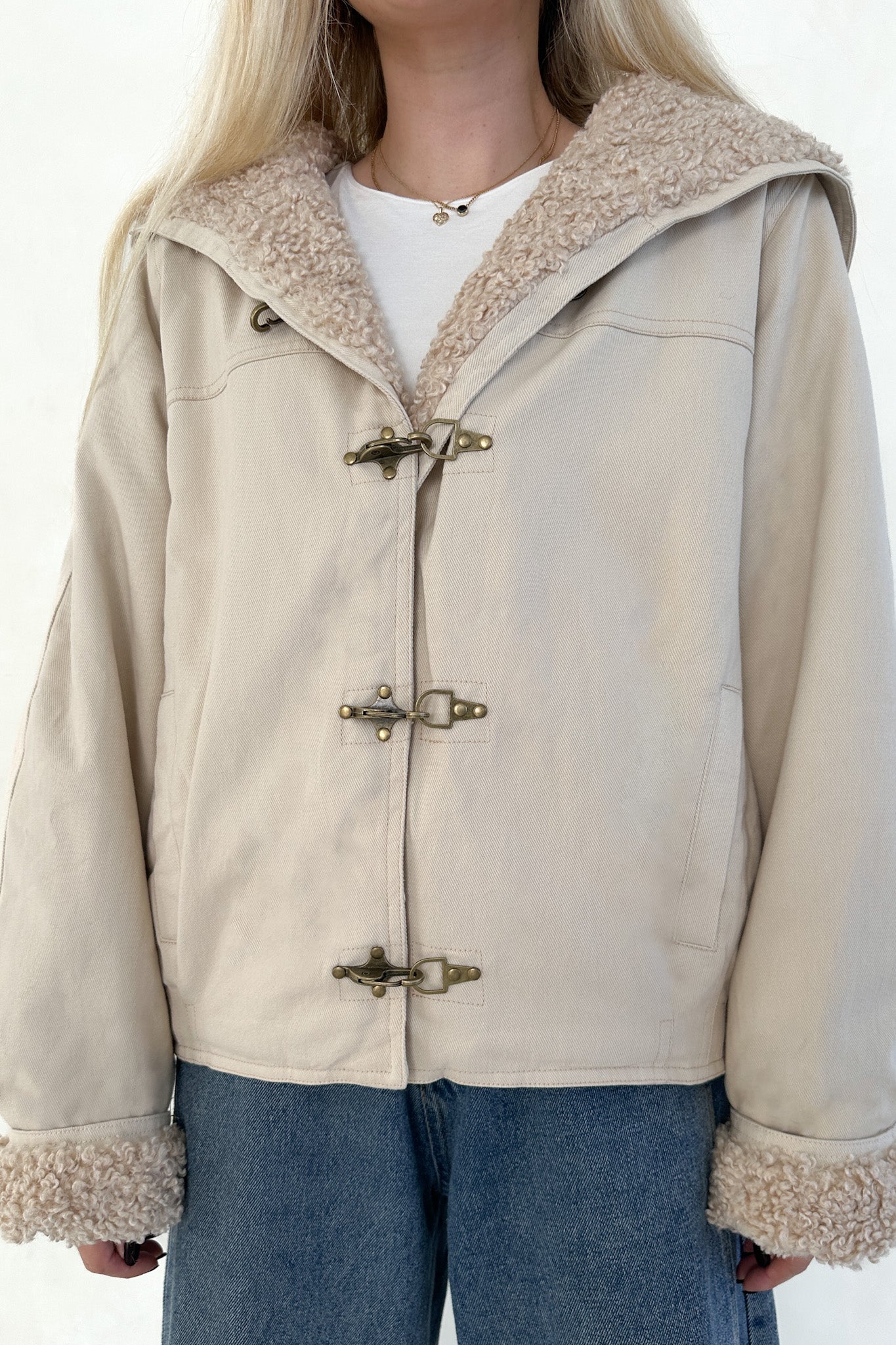 Beige jacket with fur trim on a white background