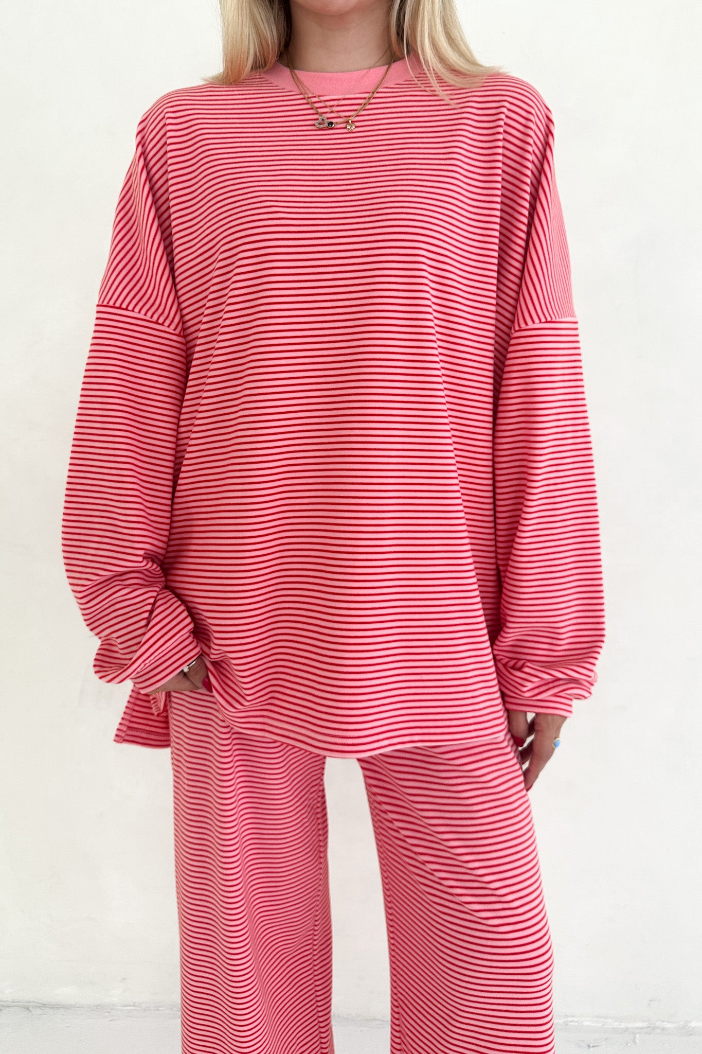 Person wearing a red and white striped outfit on a plain background