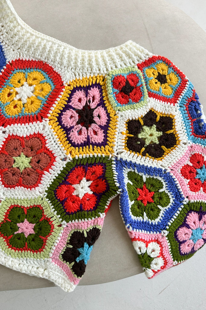 Colorful crocheted floral pattern on a white background
