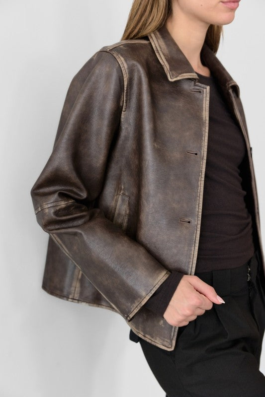 Brown leather jacket worn by a person on a white background