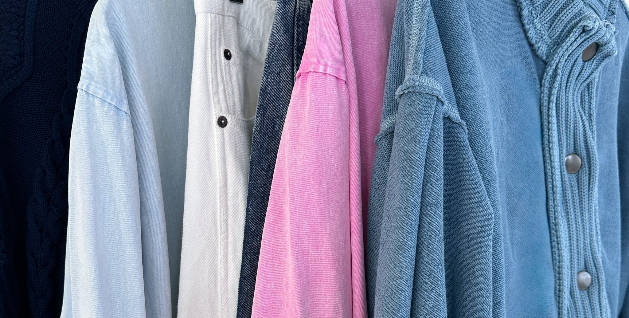 Collection of various jackets hanging on a rack