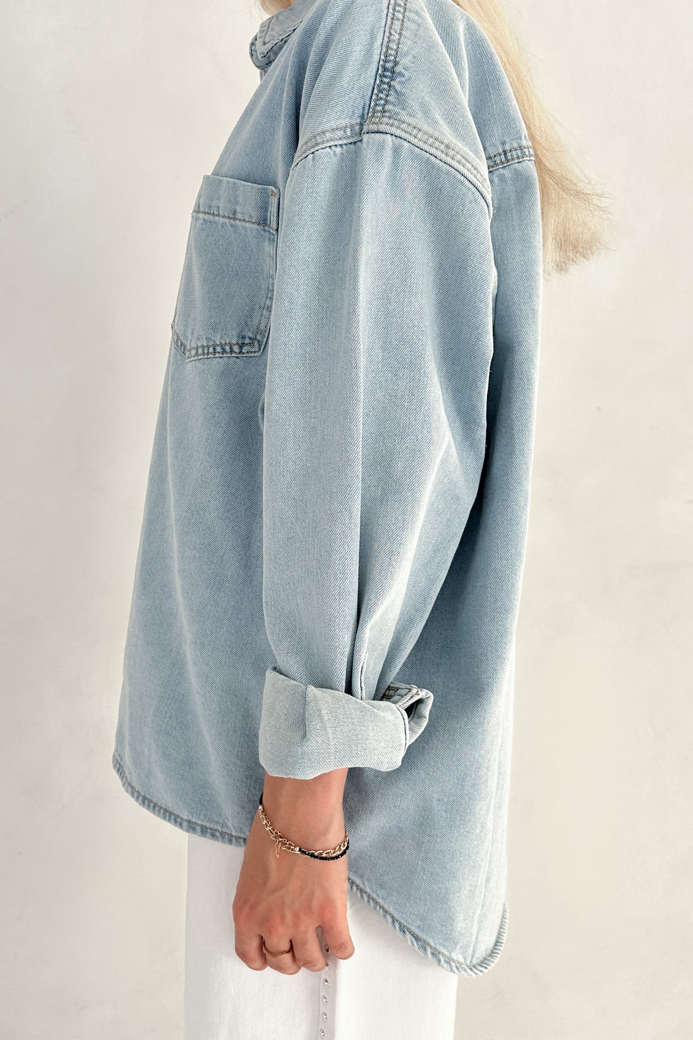 Person wearing a beige sweater in a casual indoor setting