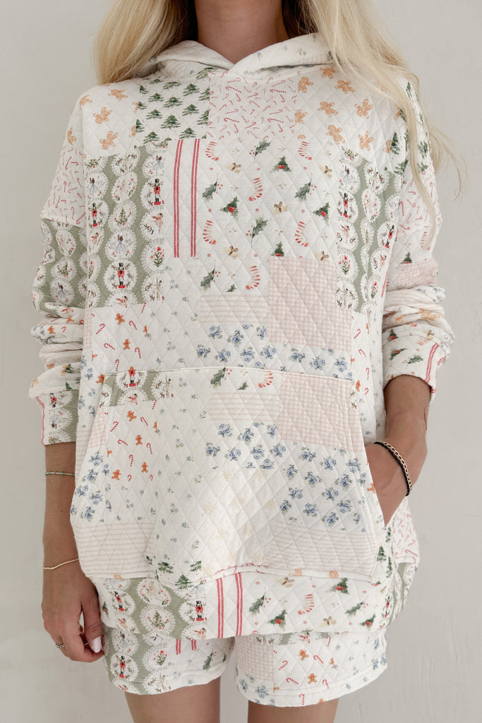 Person wearing a floral patterned outfit with a white background