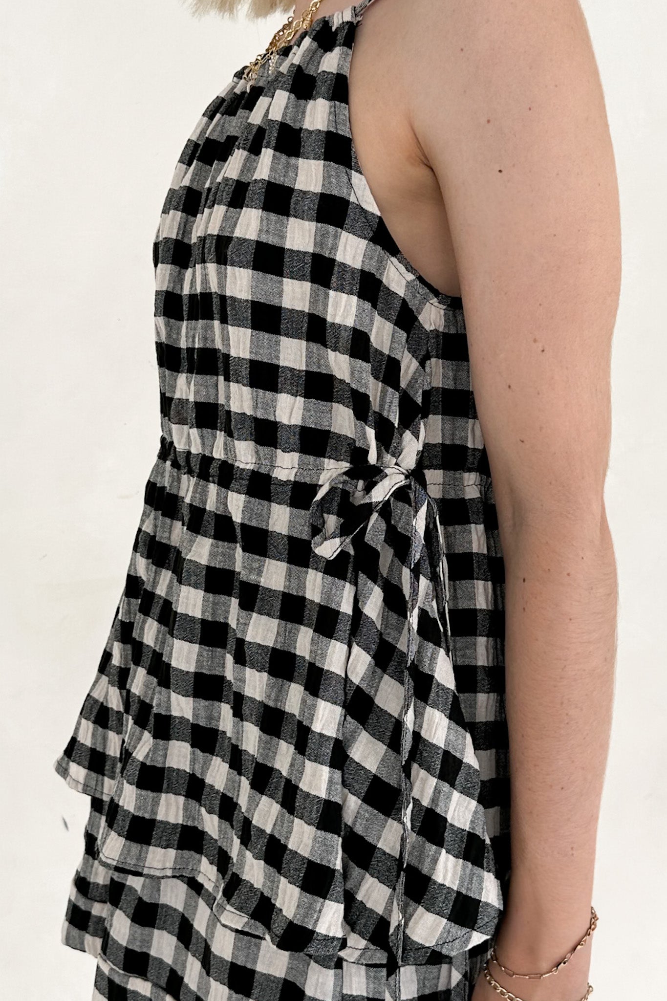 Black and white checkered dress on a person against a white background