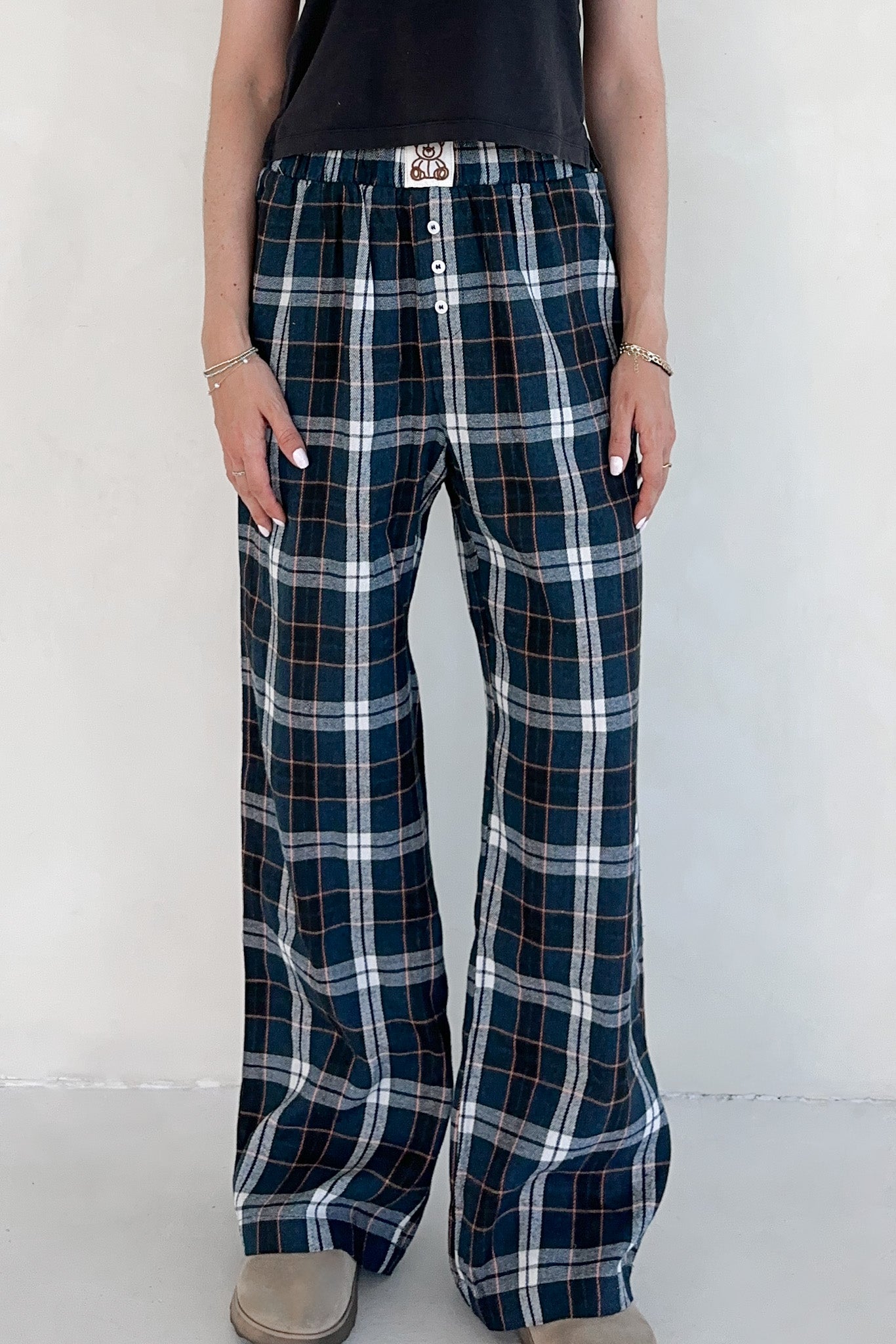 Person wearing plaid pants with a white background