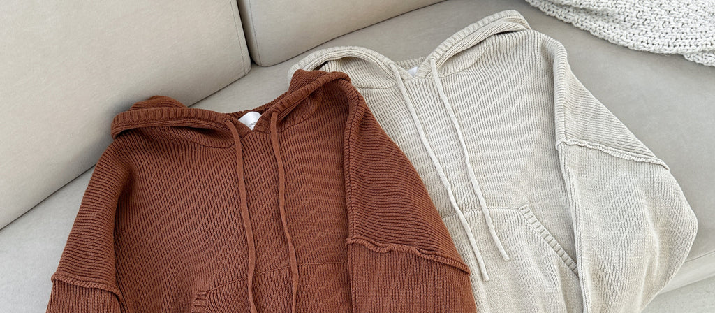 Brown and beige hoodies on a light-colored surface