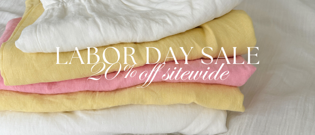 Stack of folded bedding with Labor Day sale text overlay